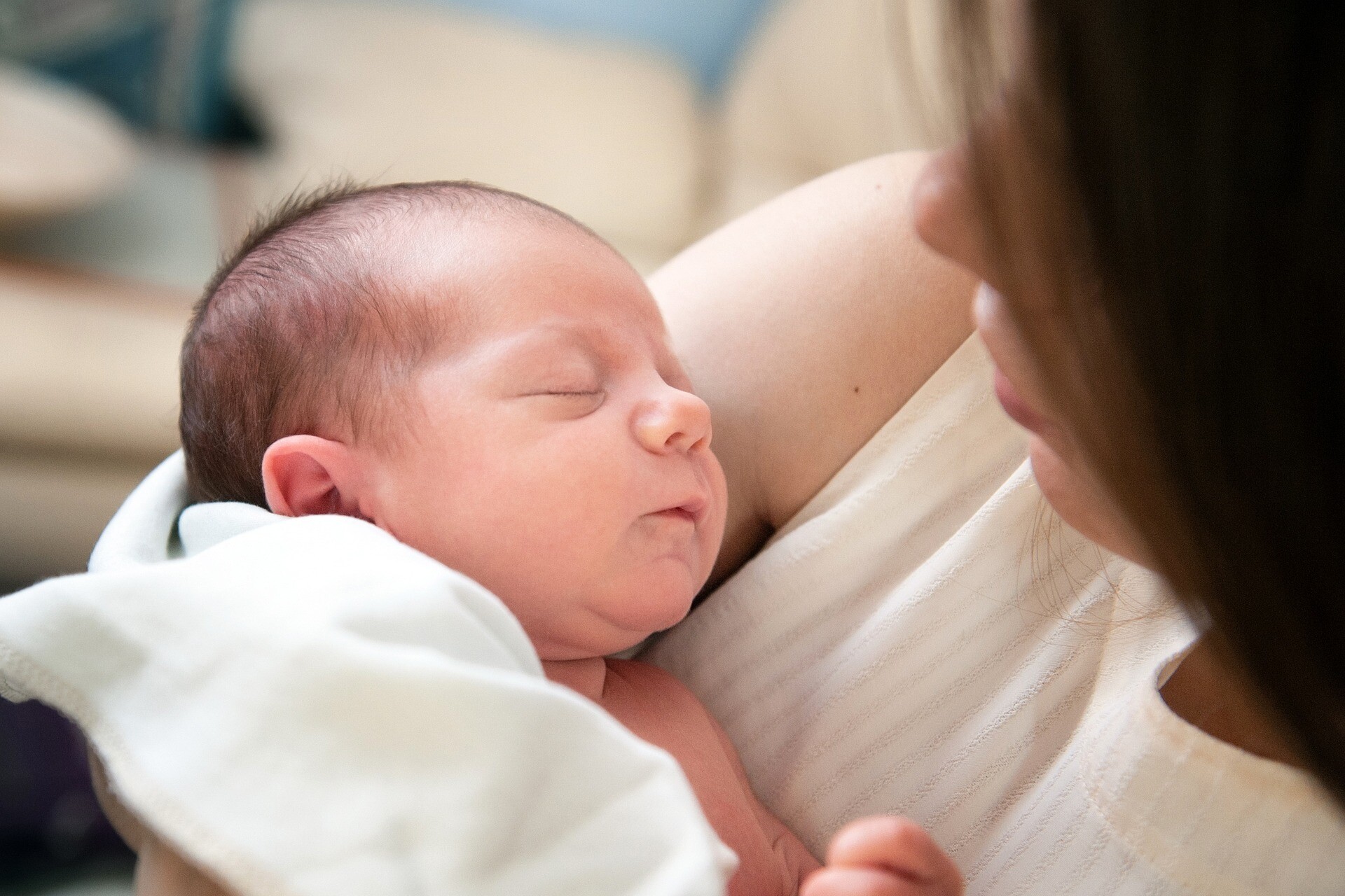 baby in blanket in mother's arms