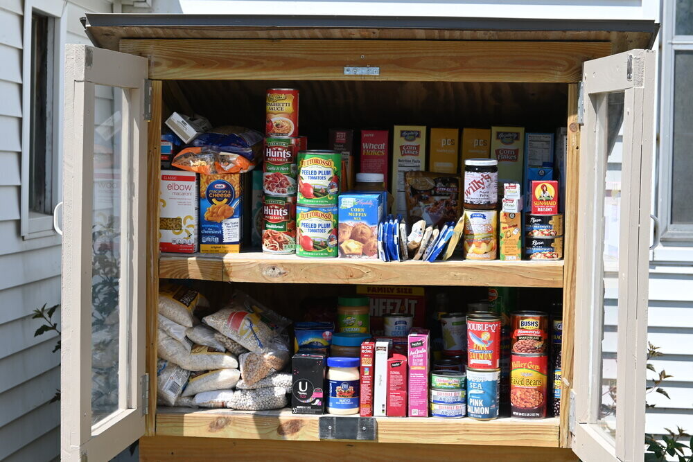 Little free pantry with doors open to show groceries